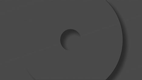 animation of grey circles and crosses spinning on grey background