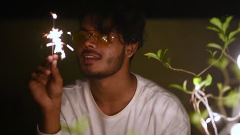 funny young boy plays with fireworks or sparklers as it ends, slow motion