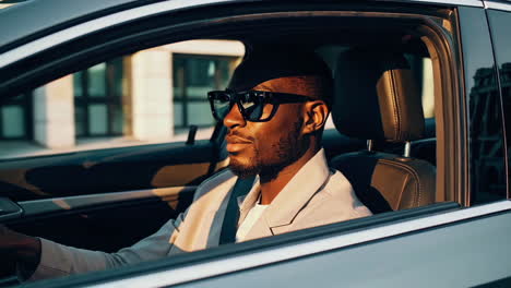 man driving a car in the city