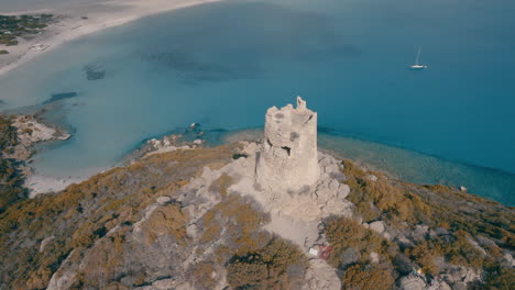 fantastic aerial shot over the torre di porto giunco in cape carbonara with the beautiful beach in the background