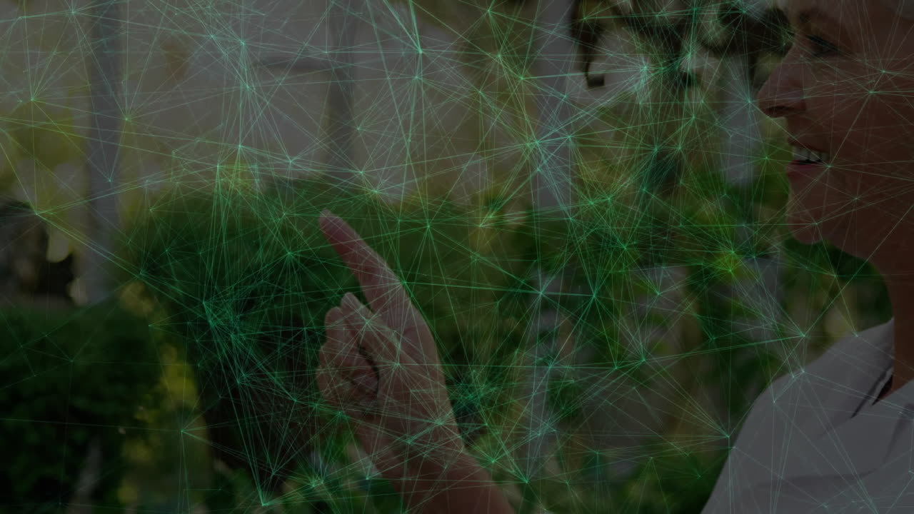 senior woman pointing forward in leafy park, showing digital network lines glowing nodes technology