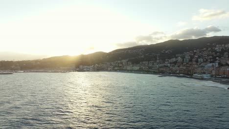 Aerial-drone-view-of-Varazze-coastline-and-beach-at-sunset,-Liguria-region-in-Italy