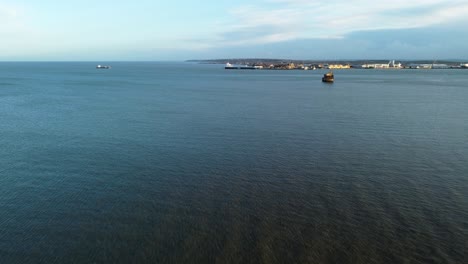 Aerial-seascape-with-a-view-on-the-coast-of-United-Kingdom,-Isle-of-Grain,-a-war-fort-and-a-coast-village-is-visible