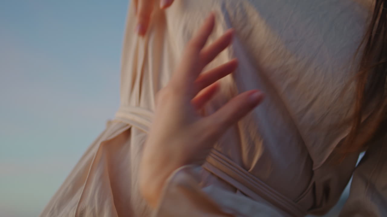 Girl dancer body improvising at sky background making hands movements closeup