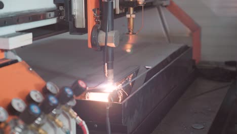 CNC-machine-cutting-holes-in-metal-plate,-establisher