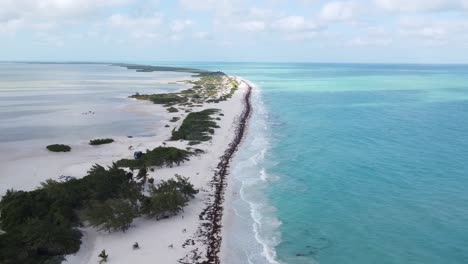 Aerial-view-of-Isla-Blanca-beach-with-white-sands-and-blue-Caribbean-Sea-waves-in-Cancun,-Mexico