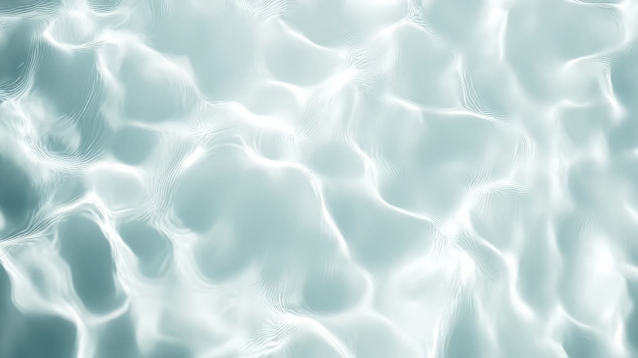 Aerial view of gentle, rippling water surface with soft light reflections, creating a serene