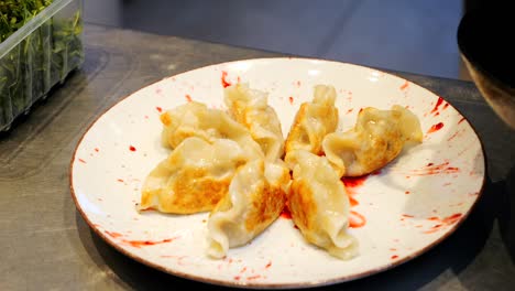 the pierogi filled with filling are placed on a plate for the restaurant guest