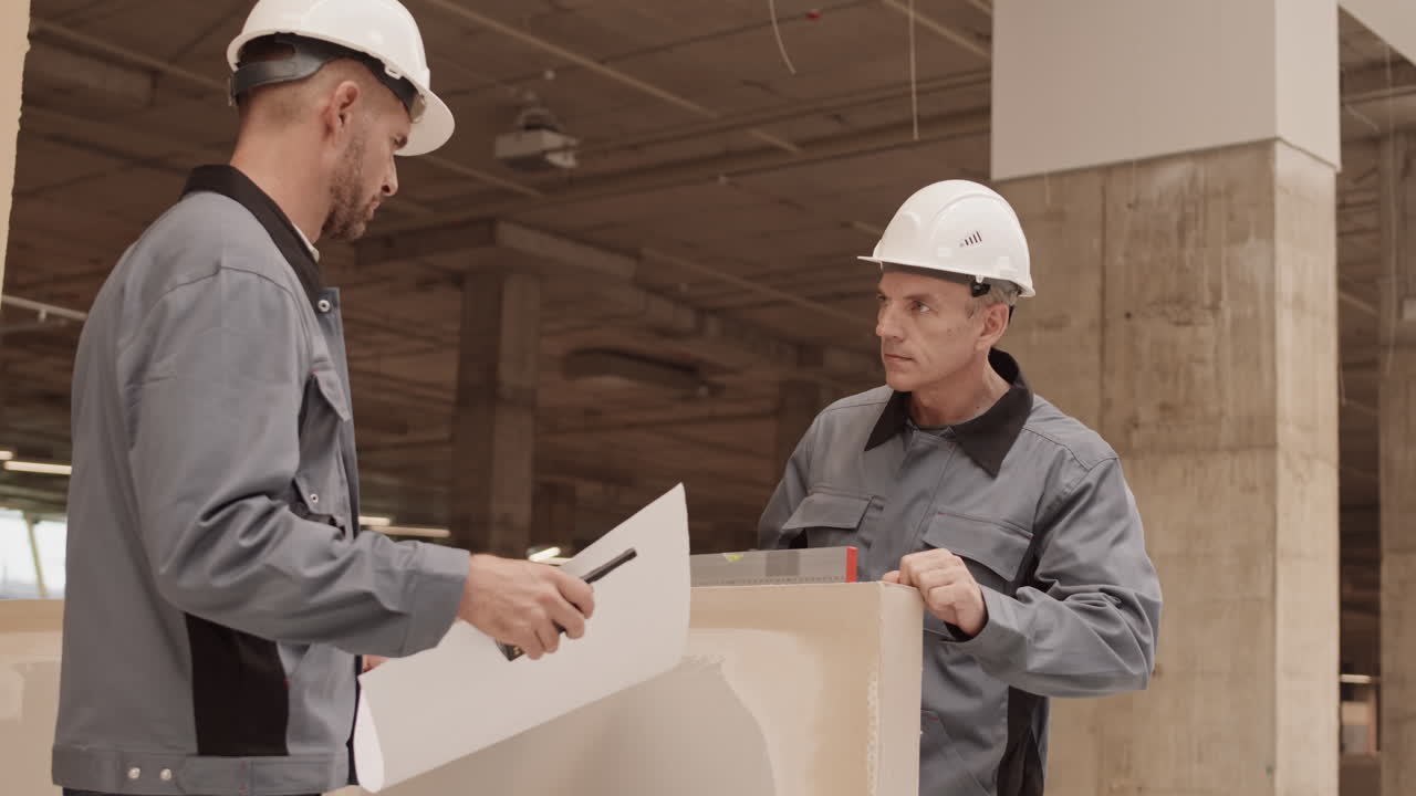 Colleagues Using Spirit Level in Construction
