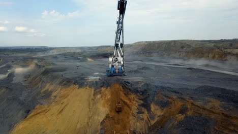 open-pit coal mine operation with heavy machinery
