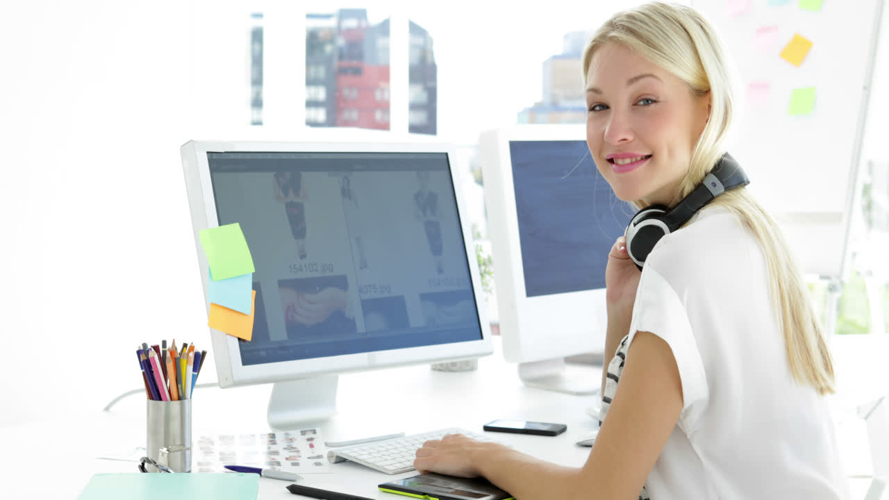 Lovely female creative designer working on her computer 