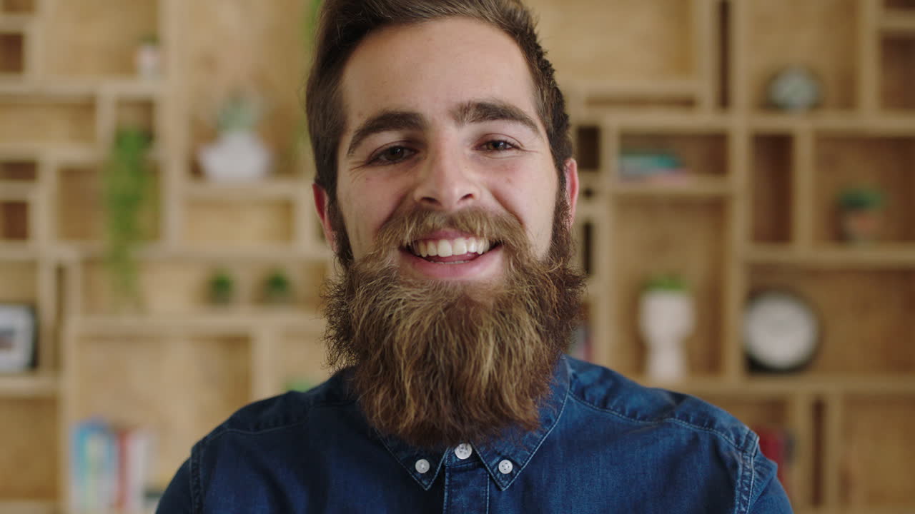 portrait of handsome young hipster businessman with beautiful beard laughing cheerful