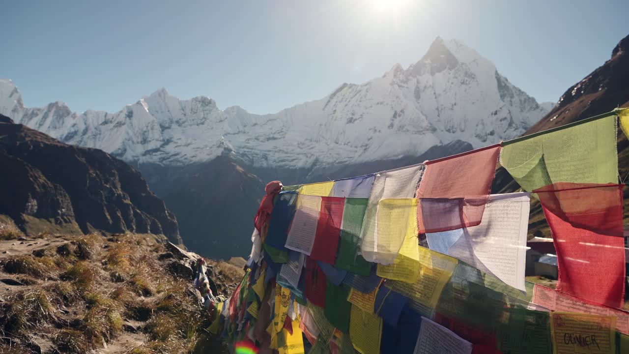 Prayer Flags Close Up in Mountains in Nepal, Colorful Tibetan Prayer Flags on Blue Sky Sunny Day in the Snowcapped Snowy Himalayas in Annapurna, Colourful Buddhism Flags in Nature