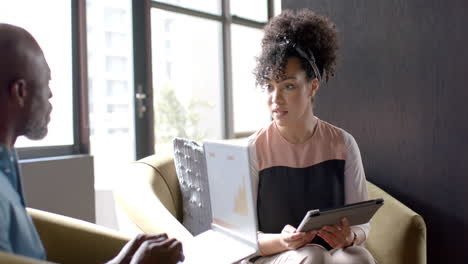 diverse business people using tablet and laptop at table with copy space