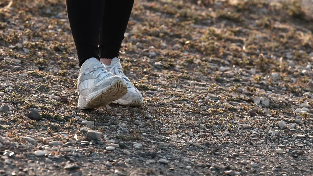 Girl in black clothes drinking water after training, exhausted