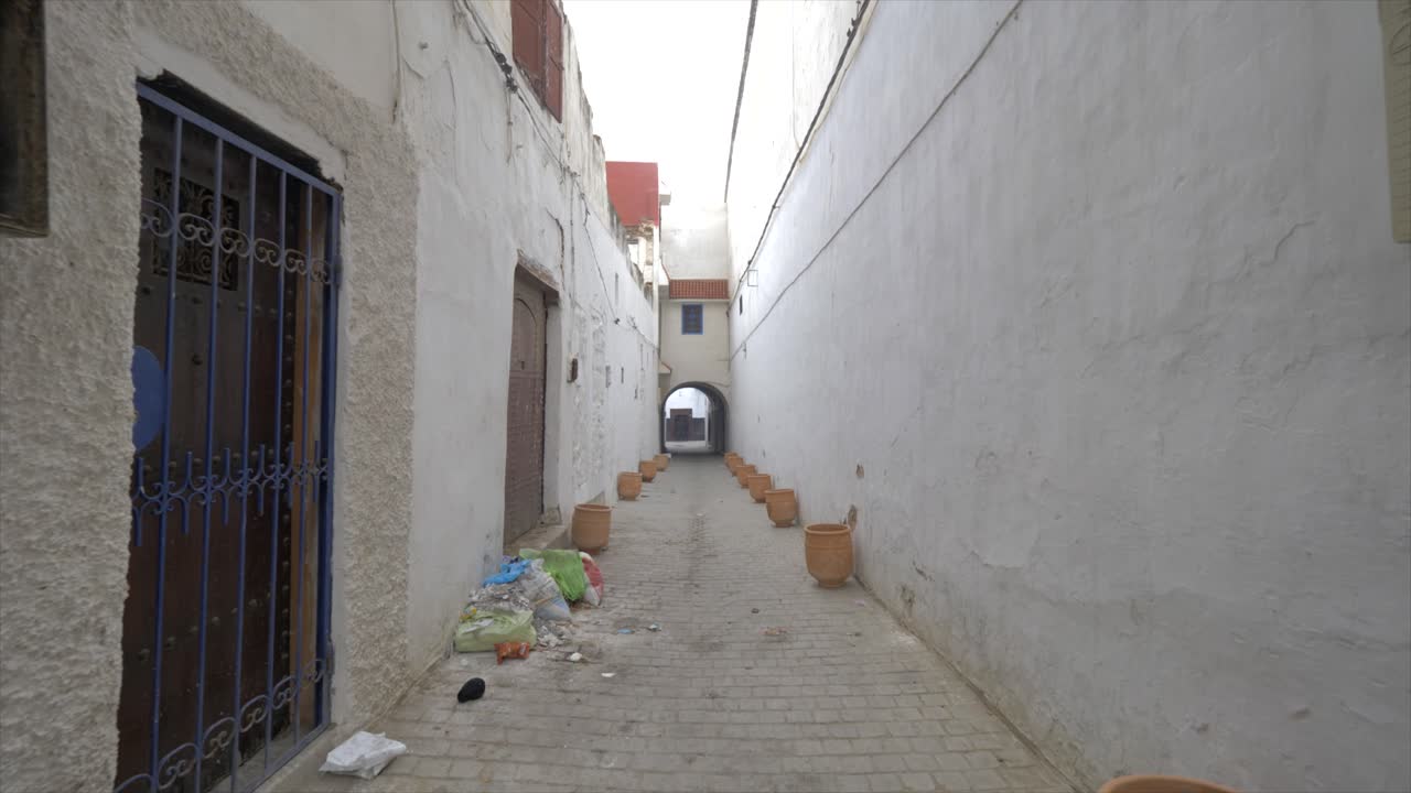 trash in old city of rebate morocco street in front of doors. video with environmental issues in Morocco. Cleanliness is a part of faith for Muslims
