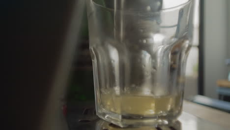 water with coffee residue drains into the glass