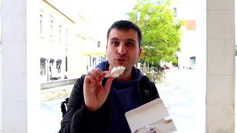 Tourist-man-delights-Ovos-Moles-of-Aveiro,-a-tasty-traditional-dessert