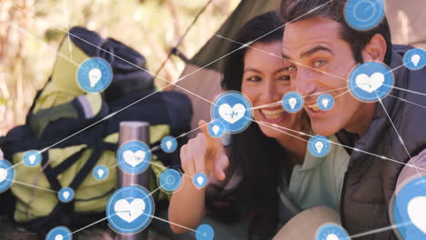 animation of network of connections with icons over caucasian couple embracing in tent