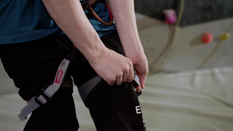 teenage boy wearing a harness indoors