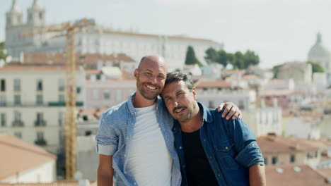 happy gay couple hugging on background of big city