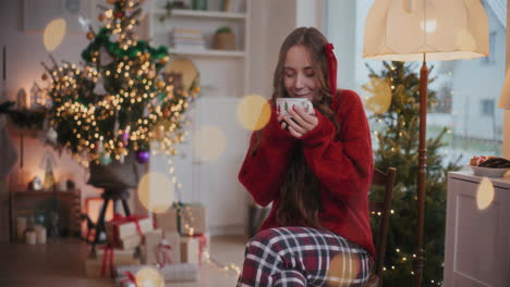 happy woman smelling coffee during christmas at home