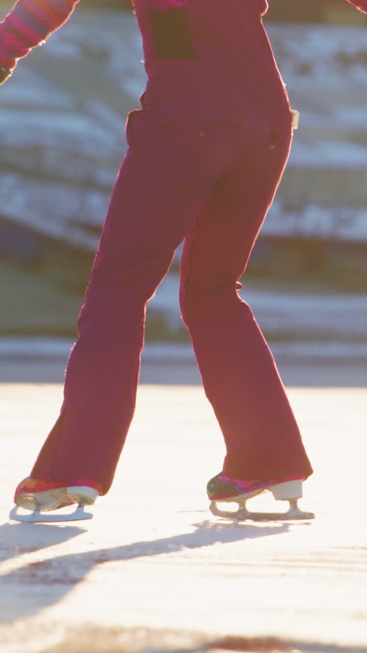 Enjoying a Day of Joyful Ice Skating on a Sunlit Frozen Surface: Two Enthusiastic Skaters Perfectly Gliding Together in Colorful Attire as the Golden Sunlight Reflects Off the Glacial Ice