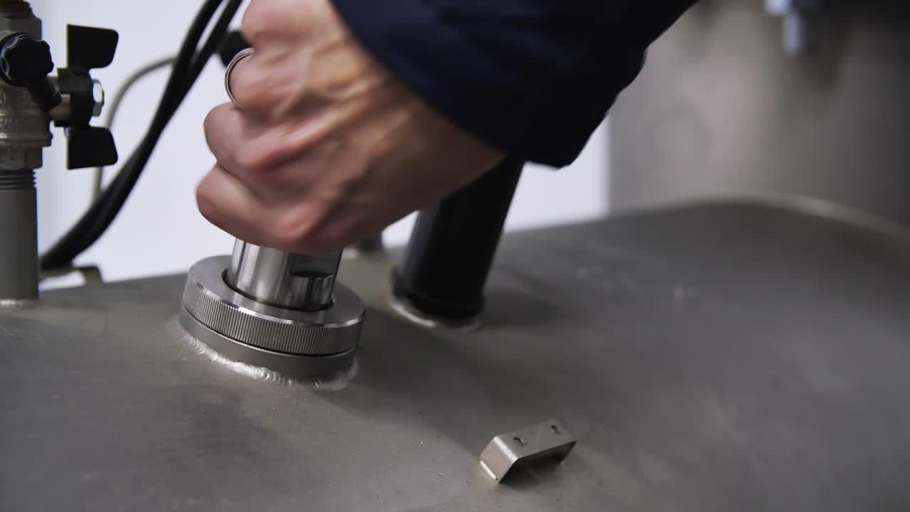 Technician Installing a Pressure Sensor on a Large Tank