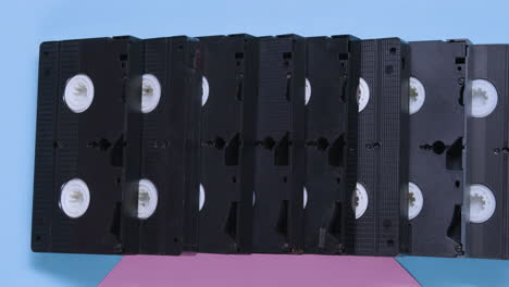 VHS-cassettes-on-blue-and-pink-pastel-background