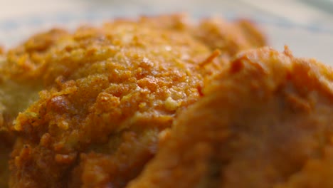 camera moving over crispy skin fried chicken in slow motion under natural sunlight. ideal for family sharing lunch or dinner. unhealthy fat fast food cooked in deep friars.