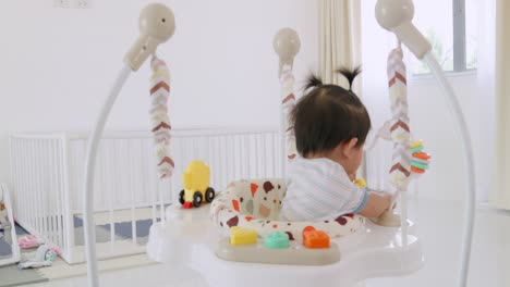 a joyful baby girl engages in playful activities in her vibrant nursery showcasing loving care.