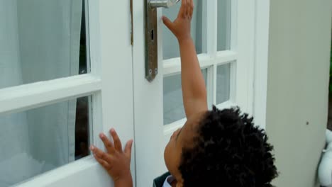 Side-view-of-cute-little-black-baby-playing-in-back-yard-of-their-home-4k