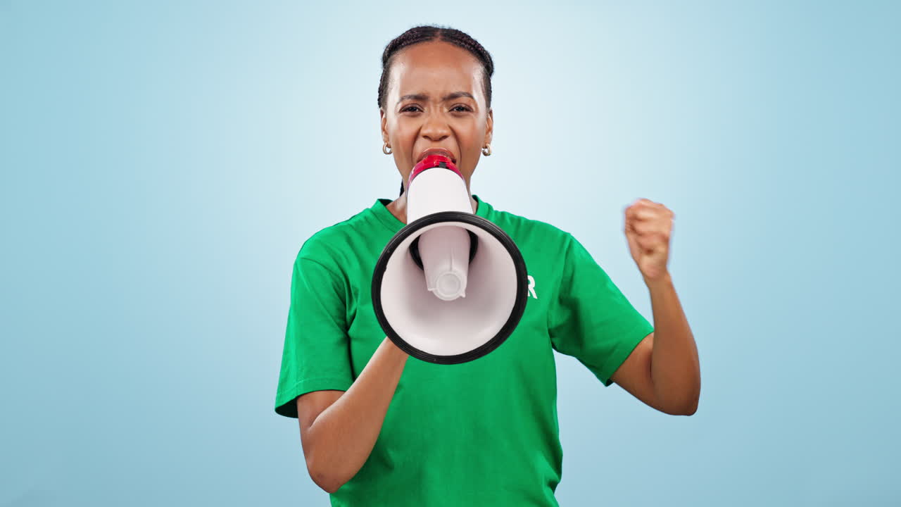Woman, volunteer and megaphone in studio on blue