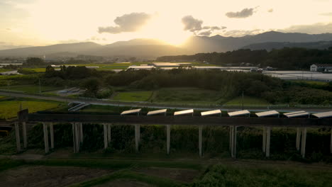 solar panels on an abandoned monorail track in japan at sunset