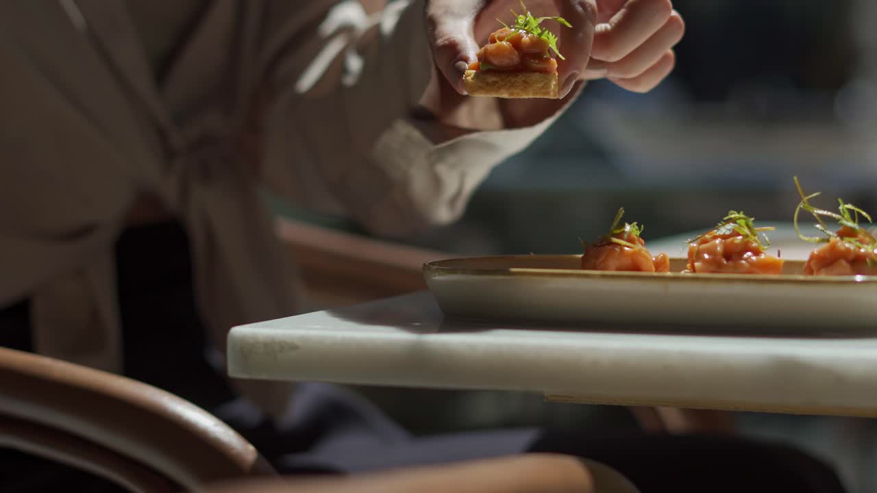A person pich a piece from his delicious food in fancy restaurant close up shot, insert shot