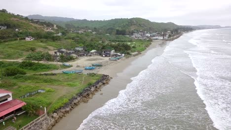 aerial drone view of waves splashing at the shore of olon beach in ecuador