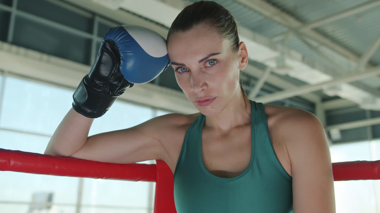 Woman Boxer Resting in Boxing Ring