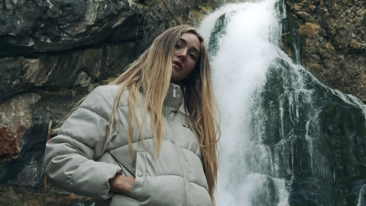 Woman in front of a waterfall in nature