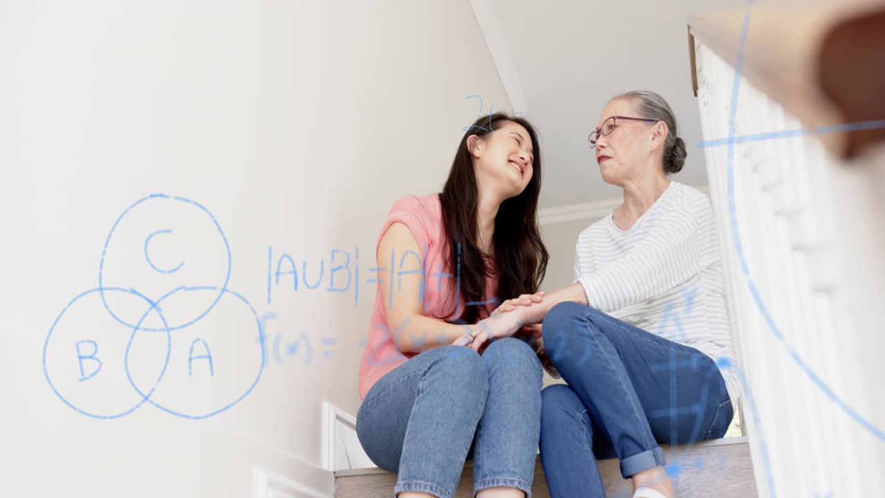Daughter reaching for mom's hand on stairs, comforting mom, blue equations overlaying wall
