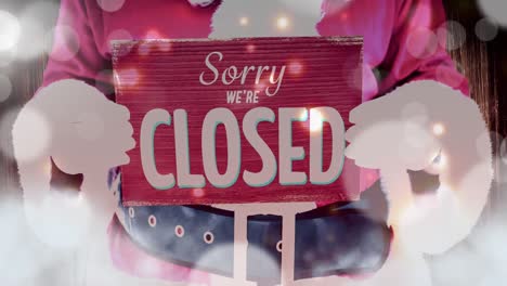 Santa-holding-Sorry-closed-sign-with-moving-lights