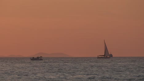 sunset sea with boats and sailboat , calm in zadar croatia