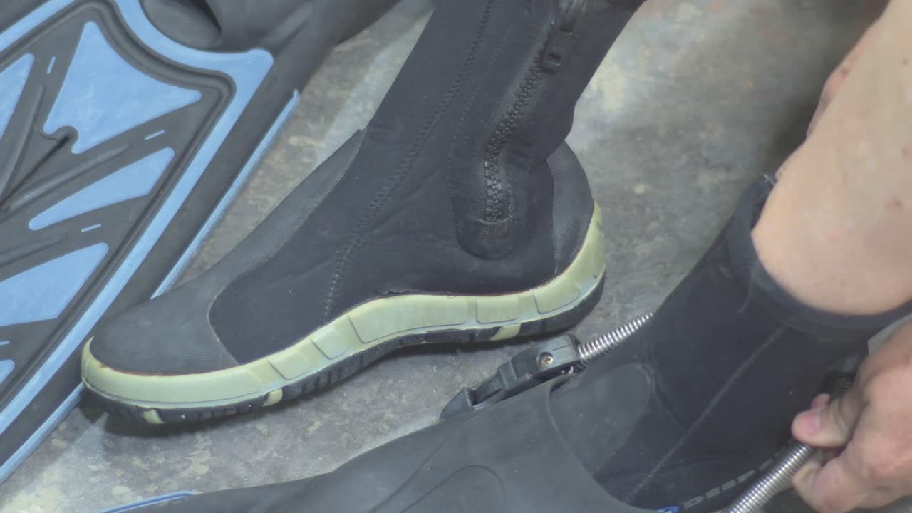 woman to put on fins, diving. Training to swim underwater, close up