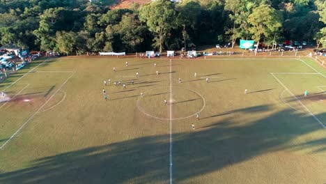 drone flies over an amateur football field in south america