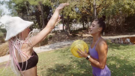 women playing with a beach ball in the park