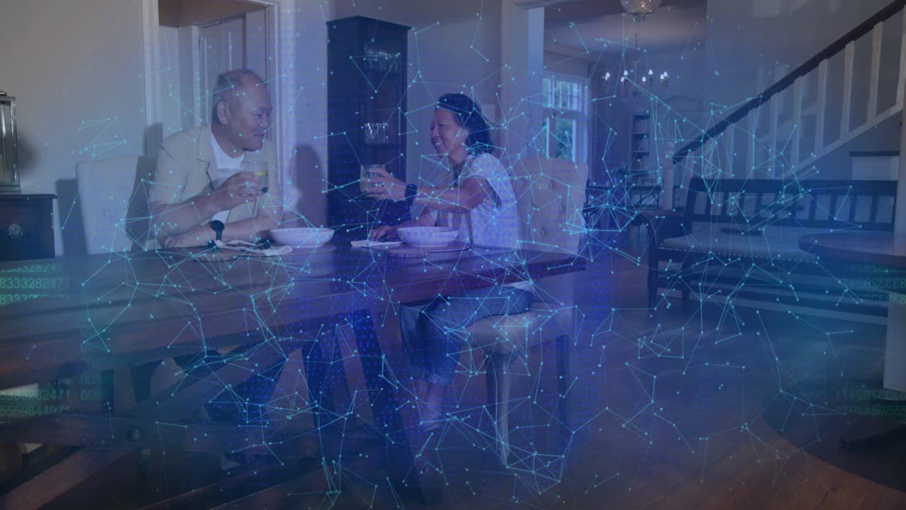 Man and woman talking at table, causing teal code resolving pulsing security shield, fading