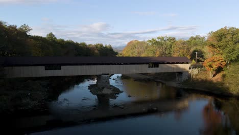 traveling concept - antique covered bridge in beautiful new england nature landscape - aerial establisher