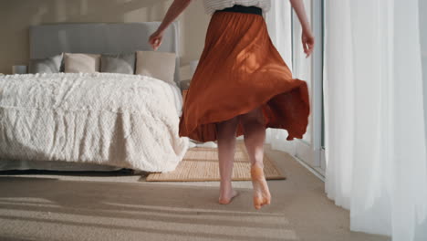 happy woman jumping on bed in hotel room having fun successful lifestyle celebrating enjoying luxury penthouse apartment