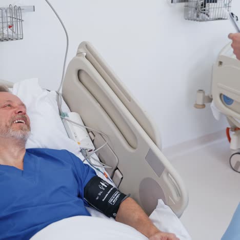 man lying in bed at hospital