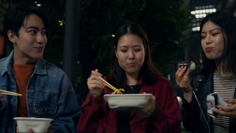 friends enjoying street food in japan at night