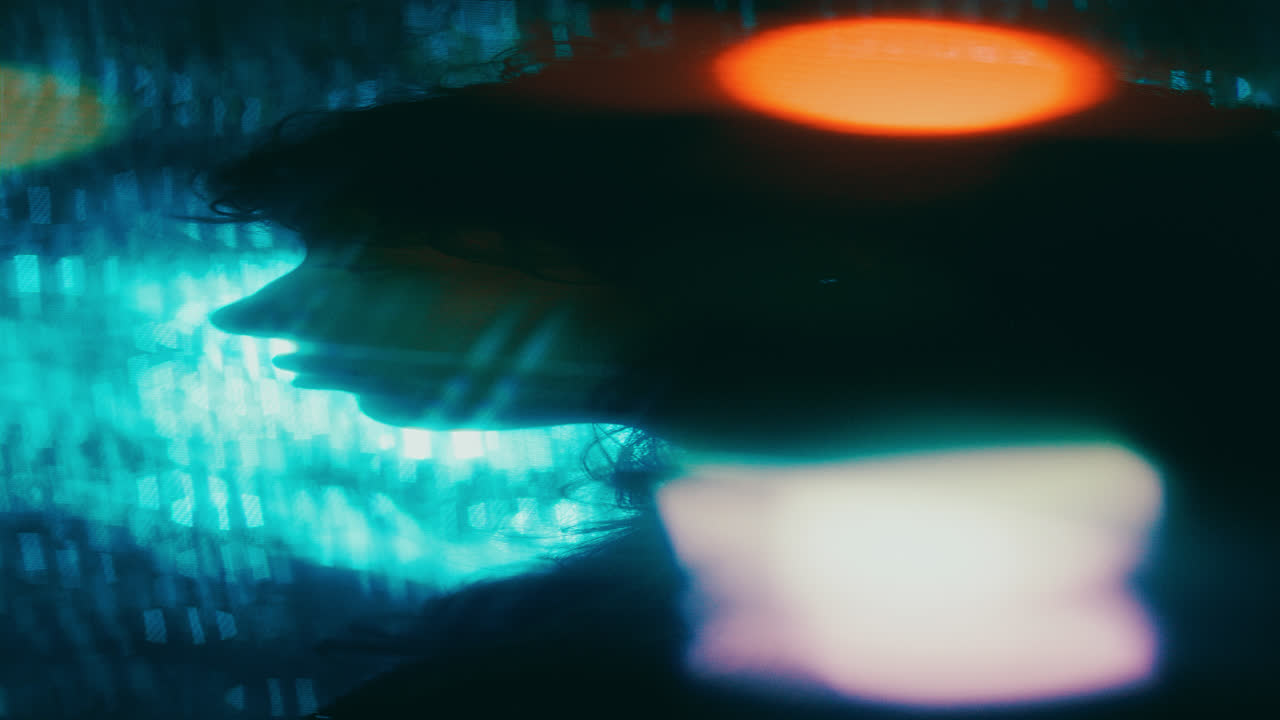 Side Profile of Silhouetted Woman behind Bokeh Lights